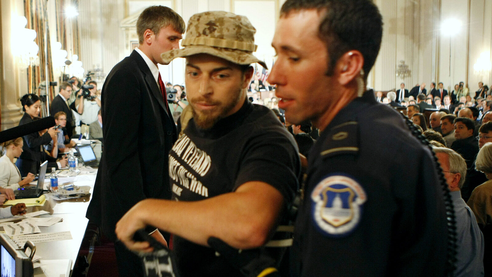 Former Marine Adam Kokesh is detained by Capitol Hill Police on Capitol Hill in Washington, Monday, Sept. 10, 2007, as Gen. David Petraeus and U.S. Ambassador to Iraq Ryan Crocker testified before the House Armed Services Committee hearing on the future course of the war in Iraq. (AP Photo/Gerald Herbert)