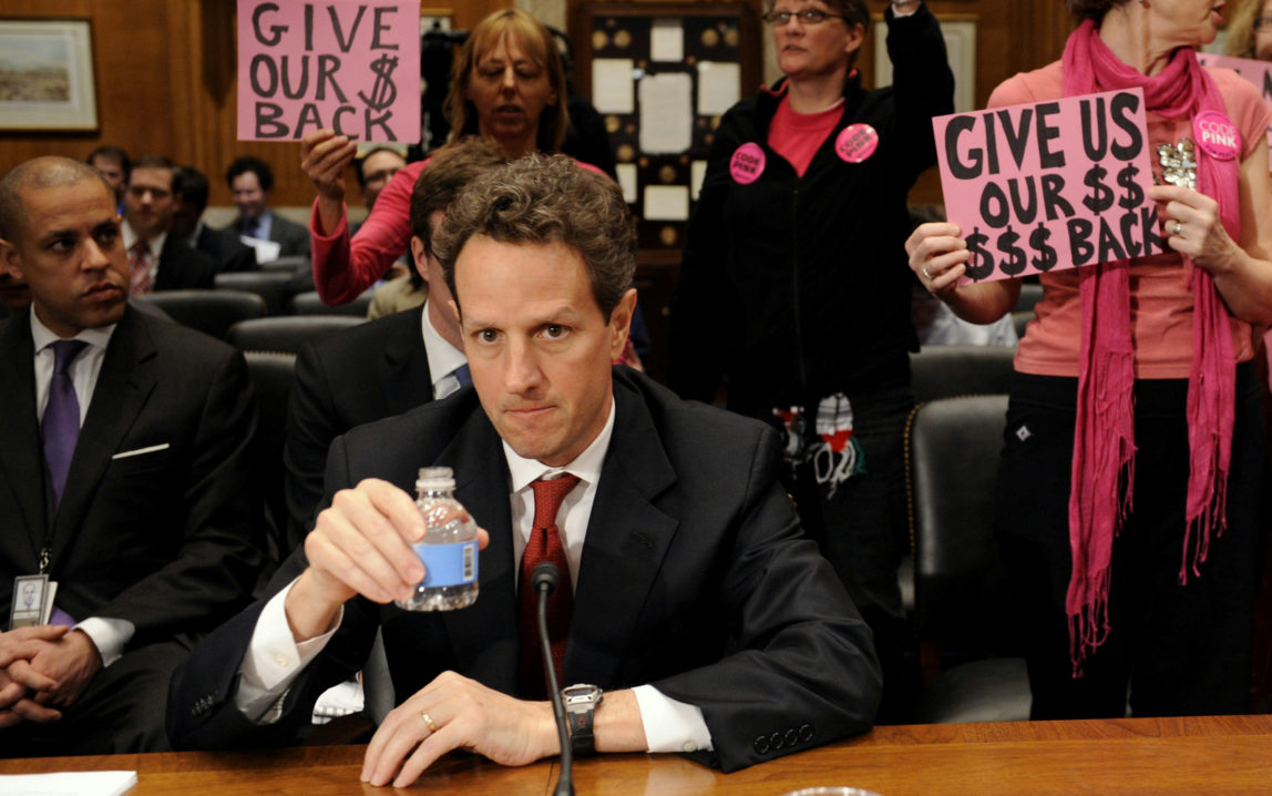 Members of CodePink stand behind Treasury Secretary Timothy Geithner on Capitol Hill in Washington, Tuesday, April 21, 2009, prior to his testifying before the Congressional Oversight Panel hearing on the Troubled Asset Relief Program (TARP).