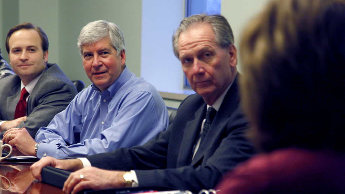 Michigan Gov. Rick Snyder, center, meets with senior staff to begin his first morning as governor, his chief of staff Dennis Muchmore, right. is married to Nestle's Michigan spokesperson Deb Muchmore. Jan. 3, 2011, in Lansing, Mich. (AP Photo/Al Goldis)