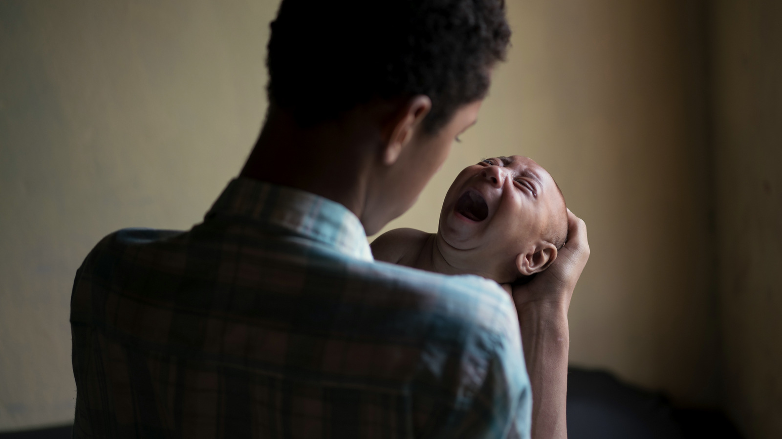 Elielson tries to calm down his baby brother Jose Wesley, in Bonito, Pernambuco state, Brazil. Jose Wesley struggles to feed, something common in children with neurological disorders like microcephaly. (AP Photo/Felipe Dana)