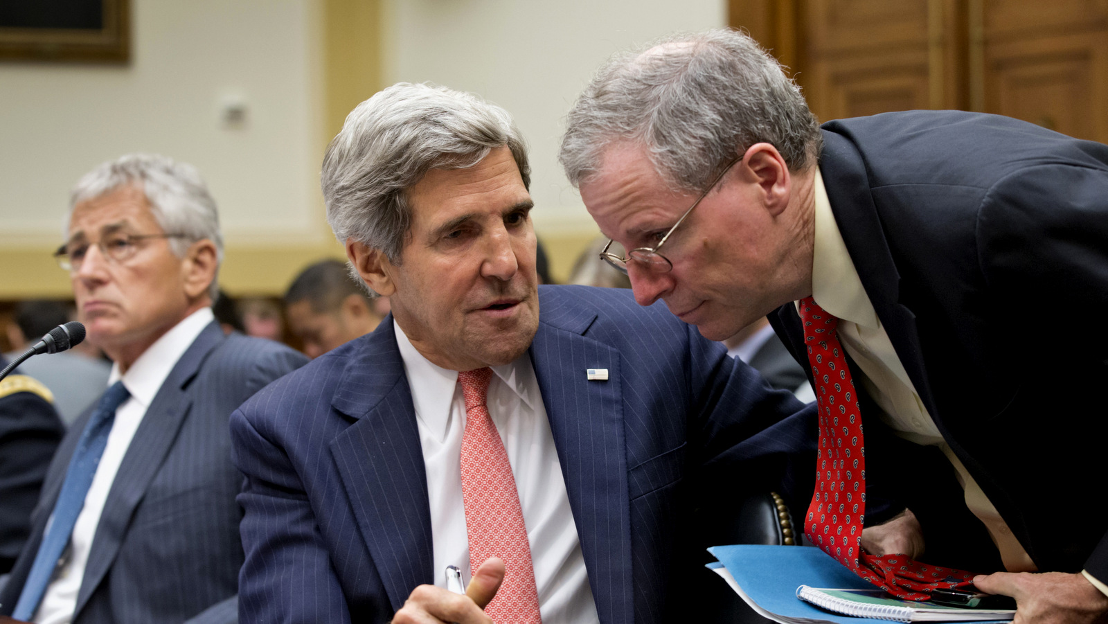 Secretary of State John Kerry confers with U.S. Ambassador to Syria Robert Ford, right, on Capitol Hill in Washington, Wednesday, Sept. 4, 2013, during a House Foreign Affairs Committee hearing on President Barack Obama's request for congressional authorization for military intervention in Syria. (AP Photo/J. Scott Applewhite)