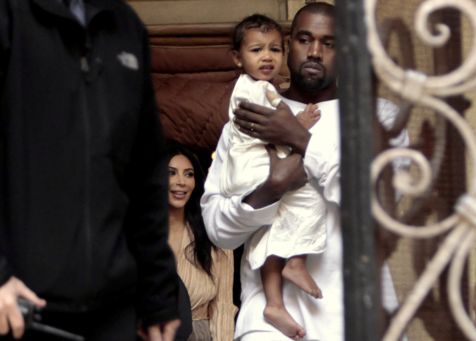 Kim Kardashian, a US reality TV star, and her husband Kanye West holding their daughter North West, walk inside Armenian St. James Cathedral, in Jerusalem, Monday, April 13, 2015. (AP Photo/Mahmoud Illean)