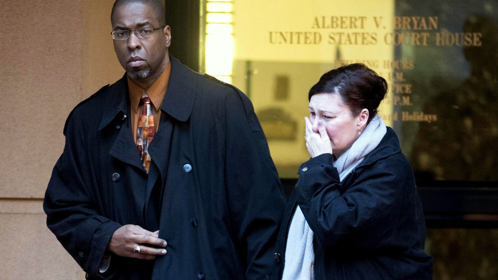 Former CIA officer Jeffrey Sterling, left, leaves the Alexandria Federal Courthouse Monday, Jan. 26, 2015, in Alexandria, Va., with his wife, Holly, center, after he was convicted on all nine counts he faced of leaking classified details of a operation to thwart Iran's nuclear ambitions to a New York Times reporter. (AP Photo/Kevin Wolf)