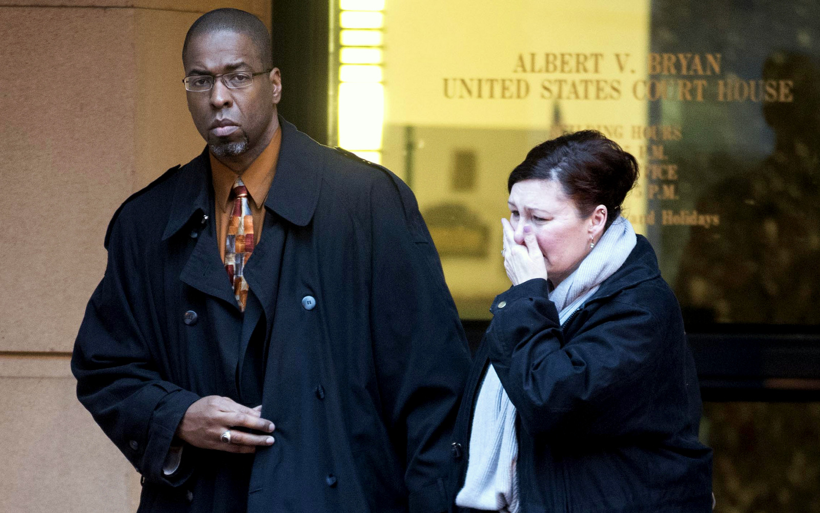 Former CIA officer Jeffrey Sterling, left, leaves the Alexandria Federal Courthouse Monday, Jan. 26, 2015, in Alexandria, Va., with his wife, Holly, center, after he was convicted on all nine counts he faced of leaking classified details of a operation to thwart Iran's nuclear ambitions to a New York Times reporter. (AP Photo/Kevin Wolf)