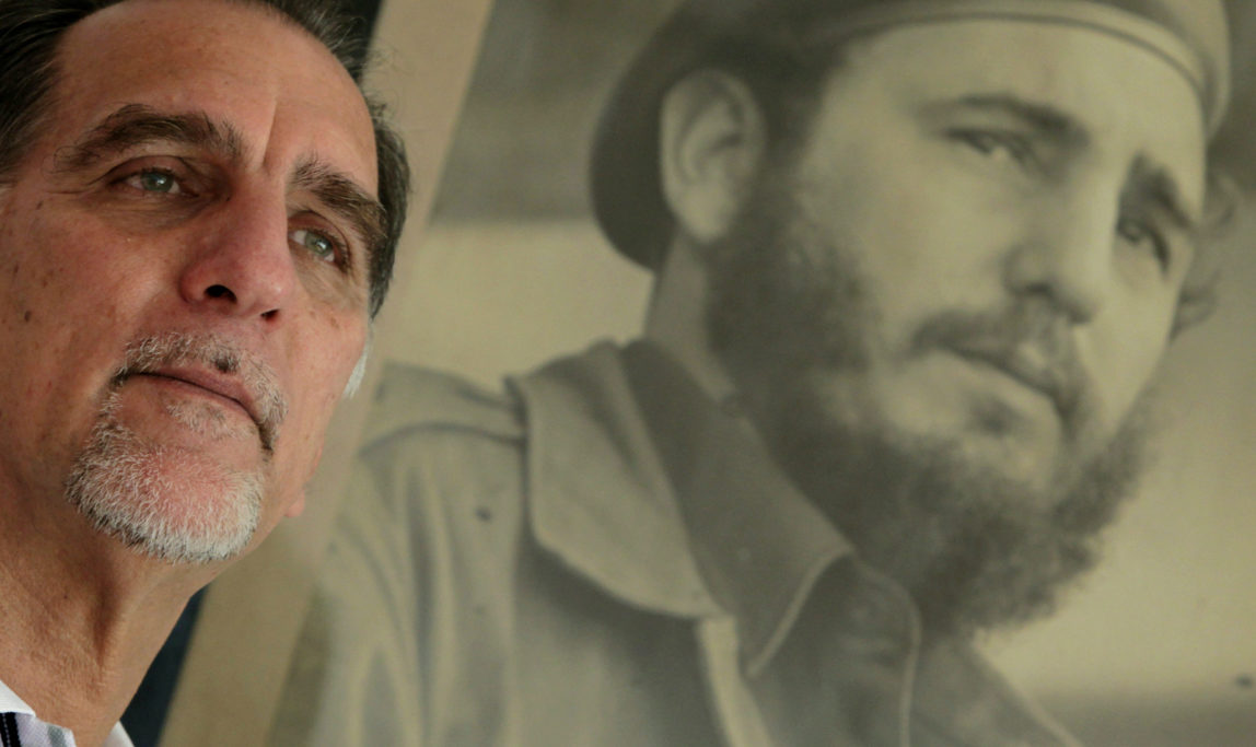 In this Feb. 17, 2014 photo, Rene Gonzalez, ofthe “Cuban Five," poses for a portrait under a framed picture of Fidel Castro in Havana, Cuba. (AP Photo/Franklin Reyes)