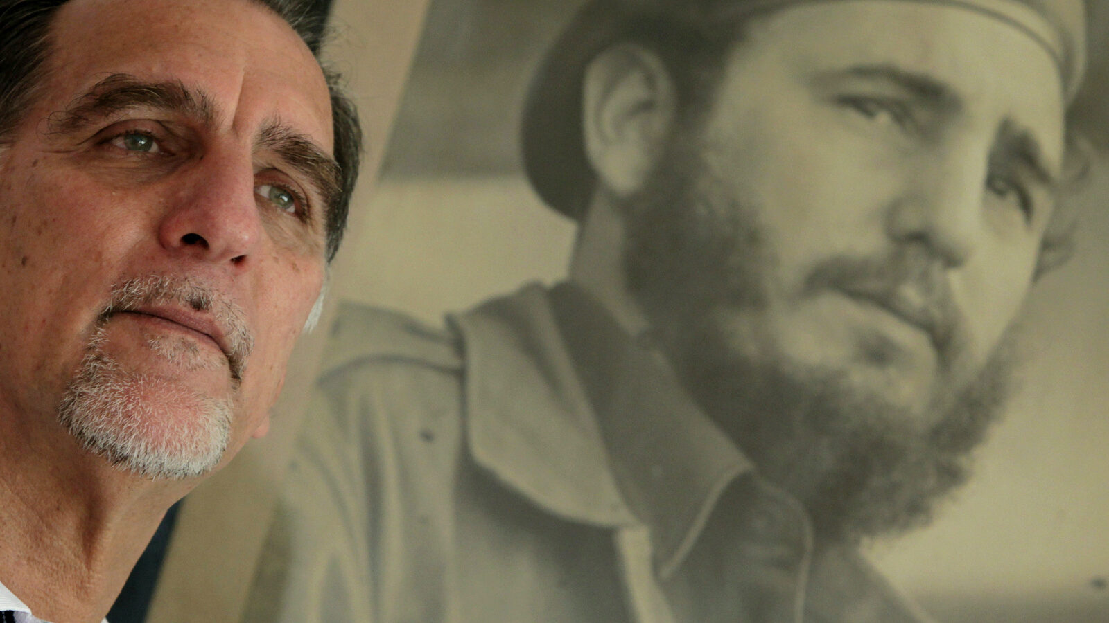In this Feb. 17, 2014 photo, Rene Gonzalez, ofthe “Cuban Five," poses for a portrait under a framed picture of Fidel Castro in Havana, Cuba. (AP Photo/Franklin Reyes)