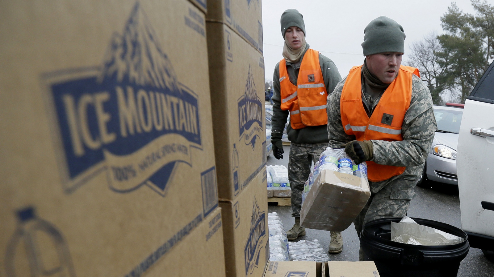 Members of the Michigan National Guard load Nestle owned Ice Mountain bottled water at a fire station, Thursday, Jan. 28, 2016 in Flint, Mich. (AP Photo/Carlos Osorio)