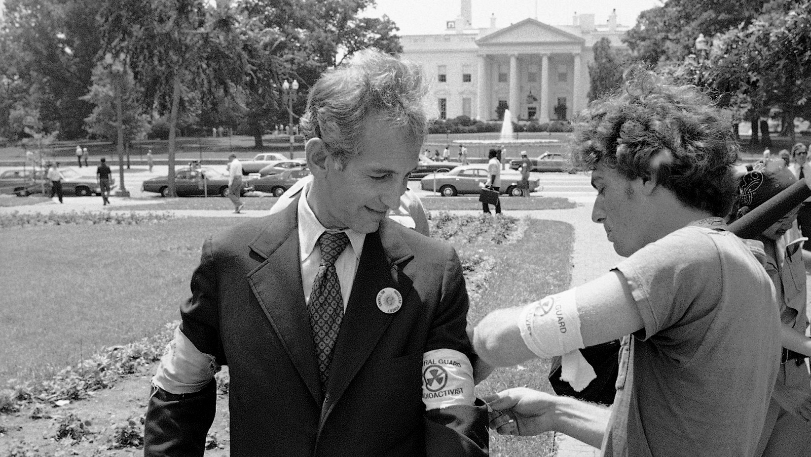Daniel Ellsberg is given an armband by a protester in Lafayette Park, Washington in front of the White House, while attending an anti-nuclear protest, June 28, 1978. (AP Photo/Jeff Taylor)