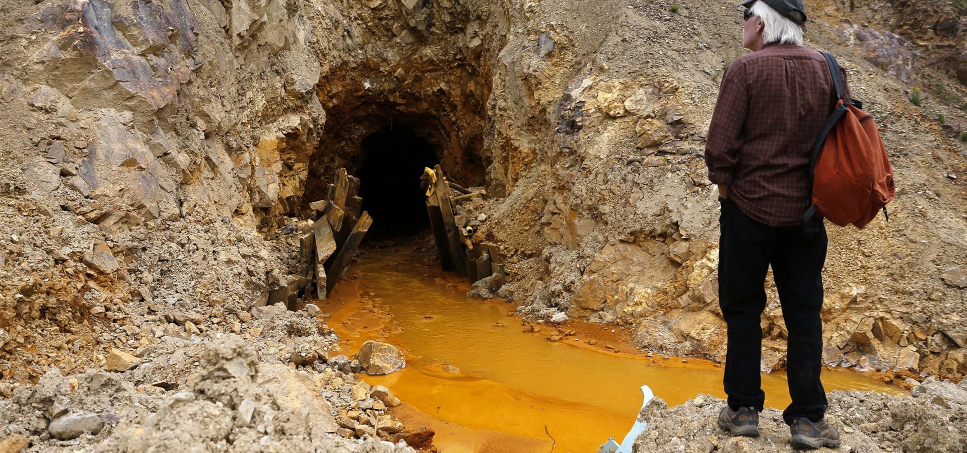 Pete McKay, San Juan County commissioner in Colorado, looks at the site Monday, Aug. 10, 2015, where the Gold King Mine breach occurred, north of Silverton. (Jon Austria, The Daily Times via The Associated Press)