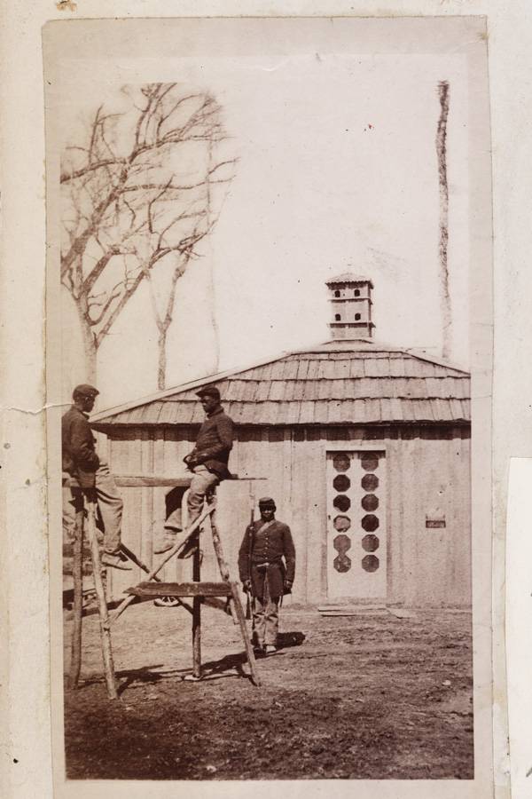 Two black soldiers of the civil war undergo punishment on the “wooden horse.” (Photo from the Huntington’s James E. Taylor collection of Civil War images)