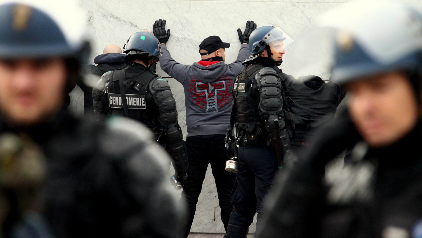 French police officers detain a man during a demonstration of extreme-right activists and supporters of PEGIDA (Patriotic Europeans against the Islamization of the West), in front of the train station in Calais, northern France, Saturday, Feb. 6, 2016. Hundreds of extreme-right activists demonstrated Saturday to "save" Calais from homeless migrants inundating the French port city in hopes of crossing the English Channel to Britain. (AP Photo/Michel Spingler)