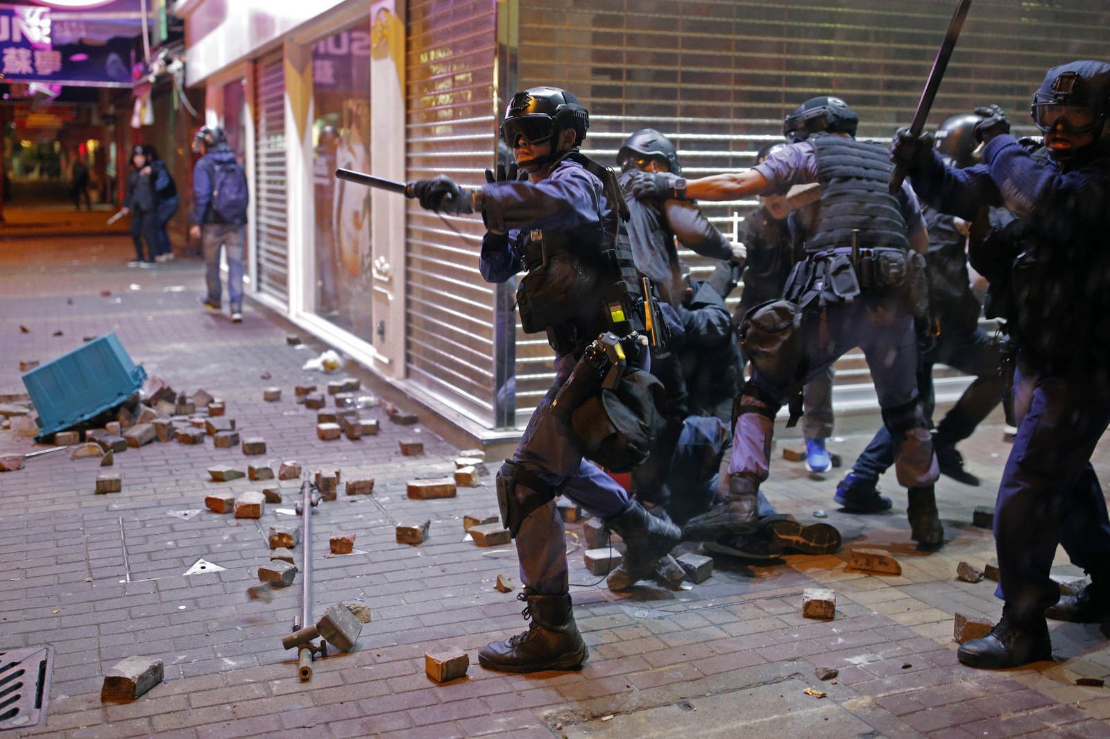 Riot police arrest a protester in Mong Kok district of Hong Kong, Tuesday, Feb. 9, 2016. (AP Photo/Vincent Yu)