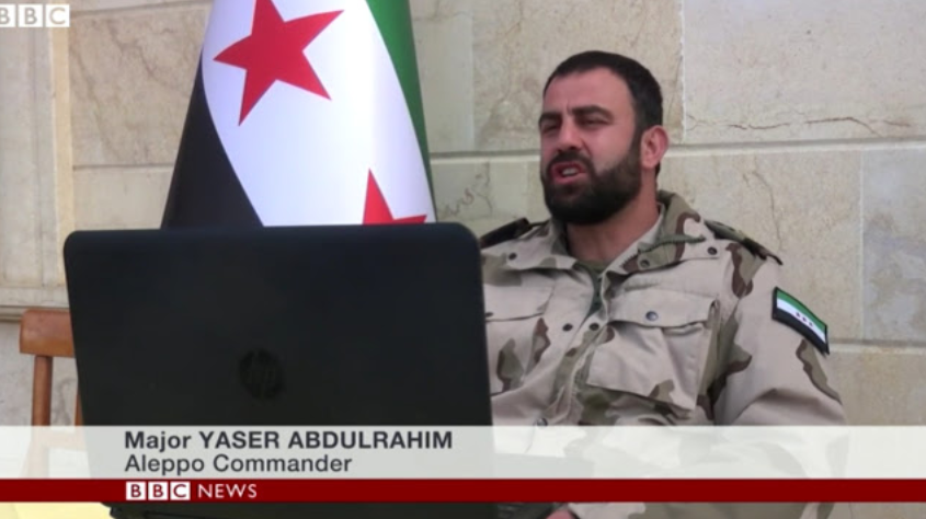 Top Image: If Major Yaser Abdulrahim looks like he’s never worn his FSA uniform out into the field, that’s because he hasn’t. He is not a member of the FSA at all, and is instead a commander of the Fatah Halab, an umbrella group for Al Qaeda affiliates armed and funded by both the US and Saudi Arabia. 