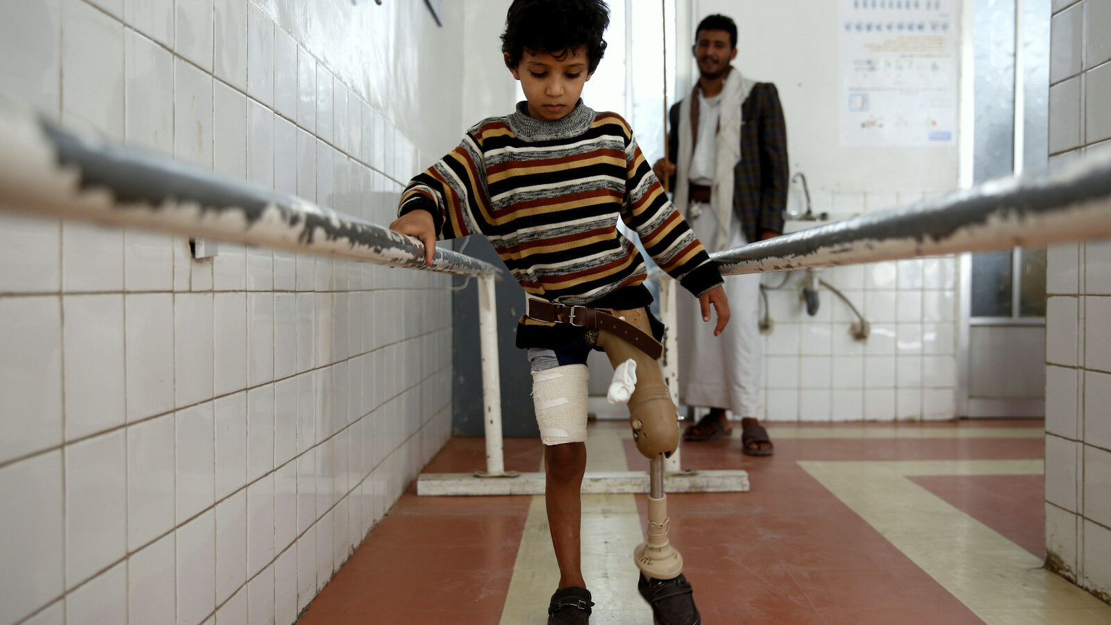 A young boy who lost his leg in the Yemen war uses a prosthetic limb at a government-run rehabilitation center in Sanaa, Yemen, Saturday, March 5, 2016. Yemen's conflict pits the government, backed by the Saudi-led coalition, against Shiite rebels known as Houthis allied with a former president. Yemen's war has killed at least 6,200 civilians and injured tens of thousands of Yemenis, and 2.4 million people have been displaced, according to U.N. figures. (AP Photo/Hani Mohammed)