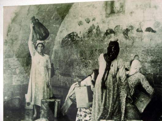 "Villagers of Sidna Ali drawing water from communal well. (source: Palestine Remembered)