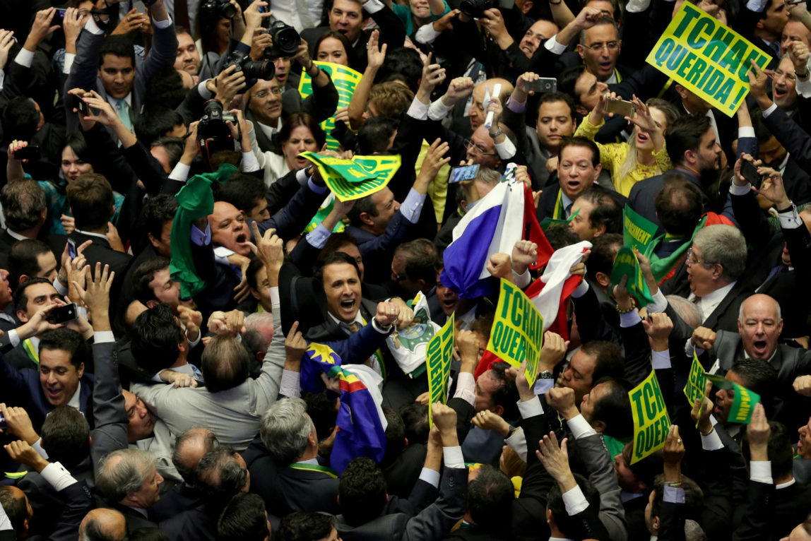 Opposition lawmakers celebrate after the lower house of Congress voted to impeach Brazil's President Dilma Rousseff in the Chamber of Deputies in Brasilia, Brazil, Sunday, April 17, 2016. The measure now goes to the Senate. Rousseff is accused of using accounting tricks in managing the federal budget to maintain spending and shore up support. (AP Photo/Eraldo Peres)