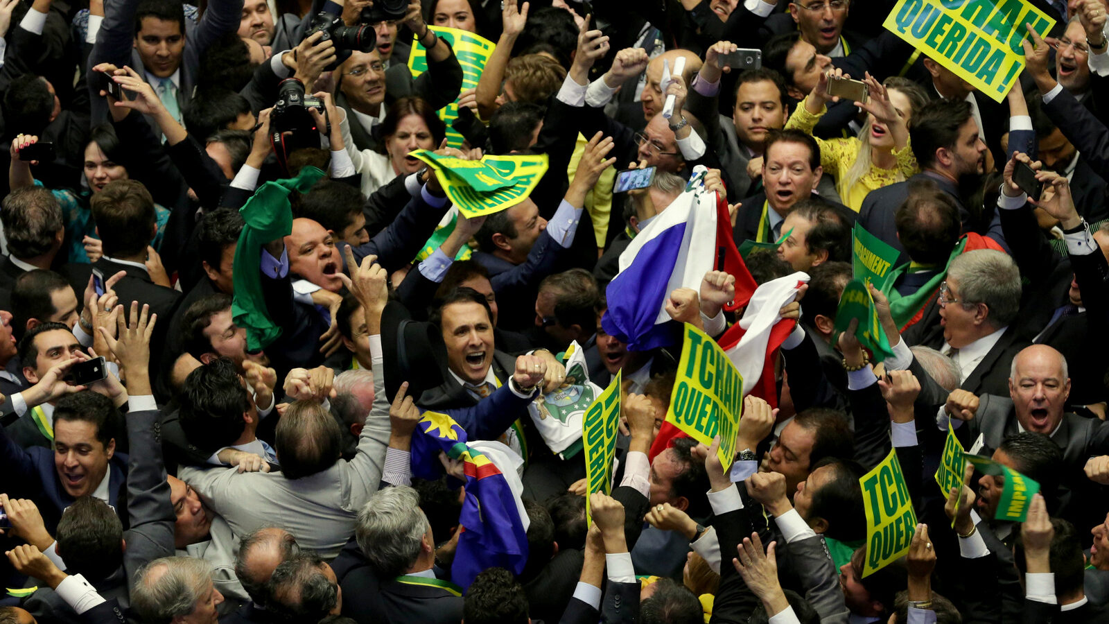 Opposition lawmakers celebrate after the lower house of Congress voted to impeach Brazil's President Dilma Rousseff in the Chamber of Deputies in Brasilia, Brazil, Sunday, April 17, 2016. The measure now goes to the Senate. Rousseff is accused of using accounting tricks in managing the federal budget to maintain spending and shore up support. (AP Photo/Eraldo Peres)