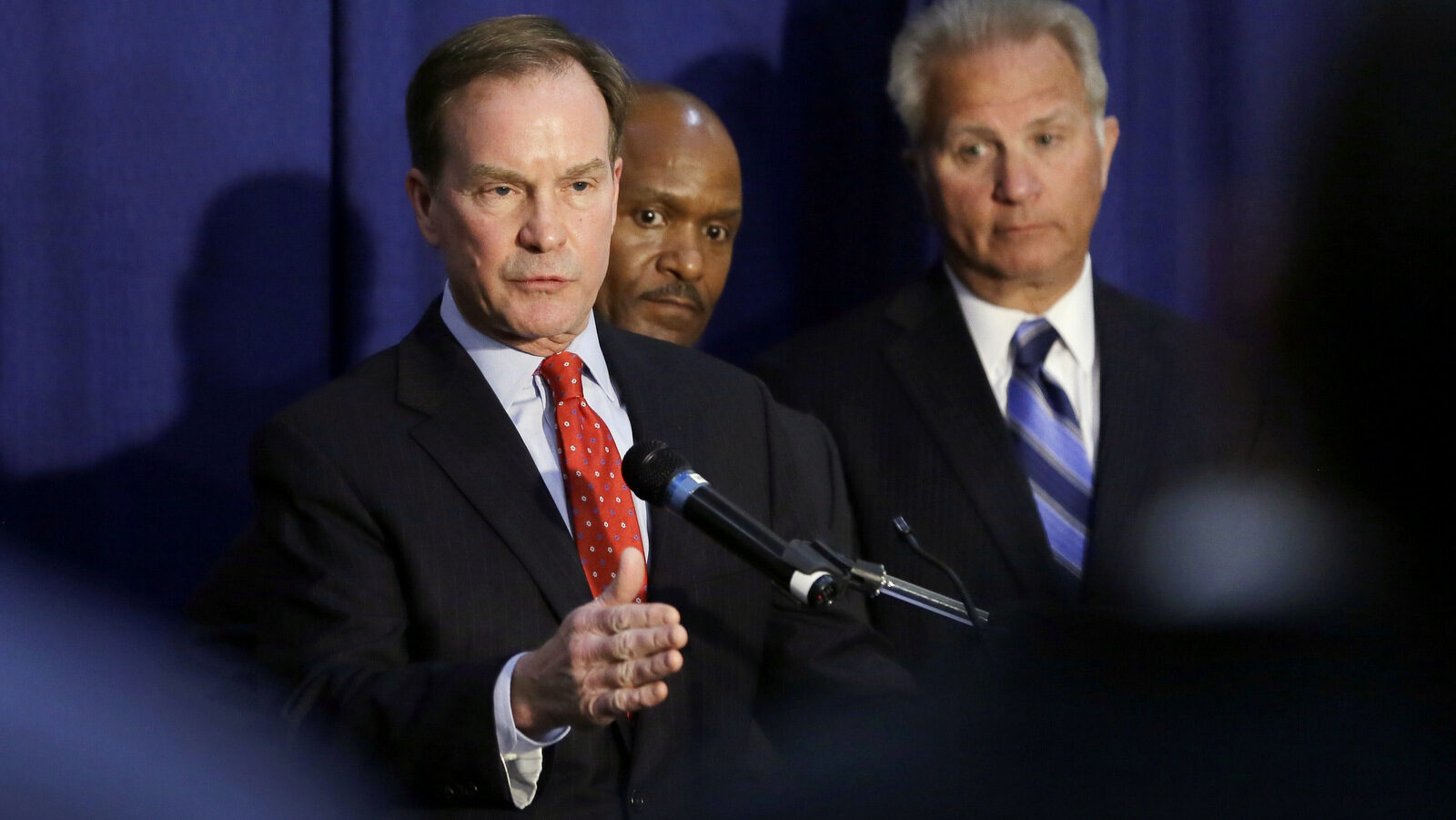 Michigan Attorney General Bill Schuette addresses the media, Wednesday, April 20, 2016, in Flint, Mich. Months after officials conceded that a series of bad decisions had caused a disaster, charges were filed against a pair of state Department of Environmental Quality employees and a local water treatment supervisor and stem from an investigation by the office of the attorney general. (AP Photo/Carlos Osorio)