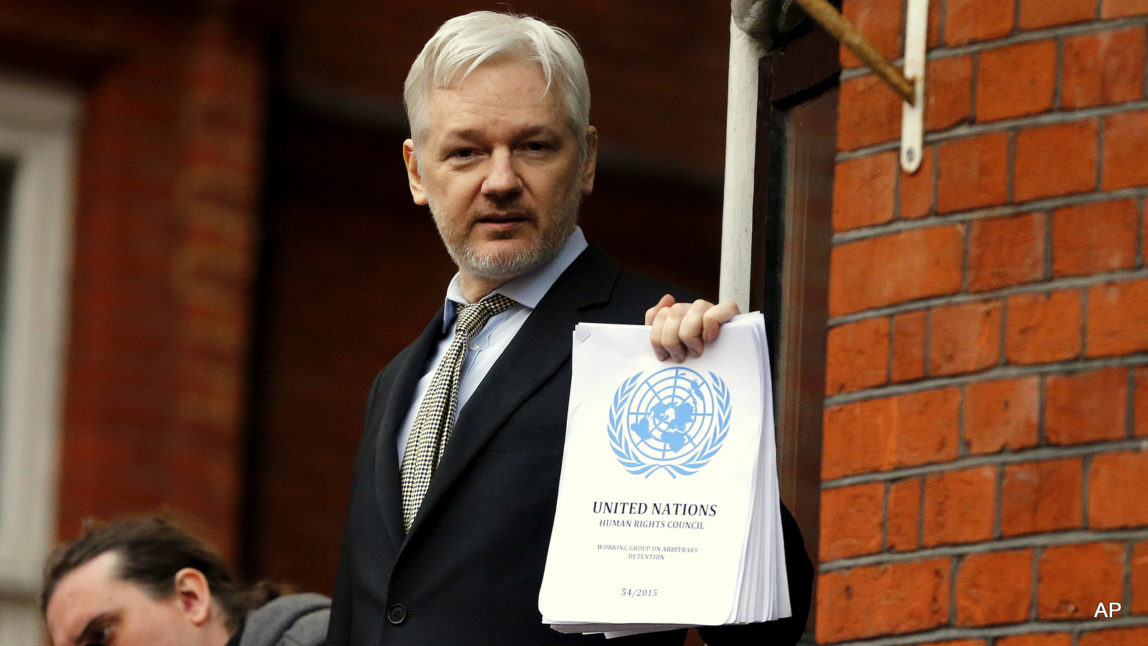 WikiLeaks founder Julian Assange stands on the balcony of the Ecuadorean Embassy to addresses waiting supporters and media in London, Friday, Feb. 5, 2016.