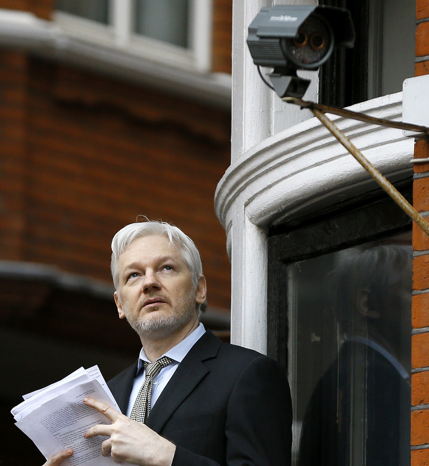 Wikileaks founder Julian Assange looks up as he speaks on the balcony of the Ecuadorean Embassy in London, Friday, Feb. 5, 2016. (AP Photo/Kirsty Wigglesworth)