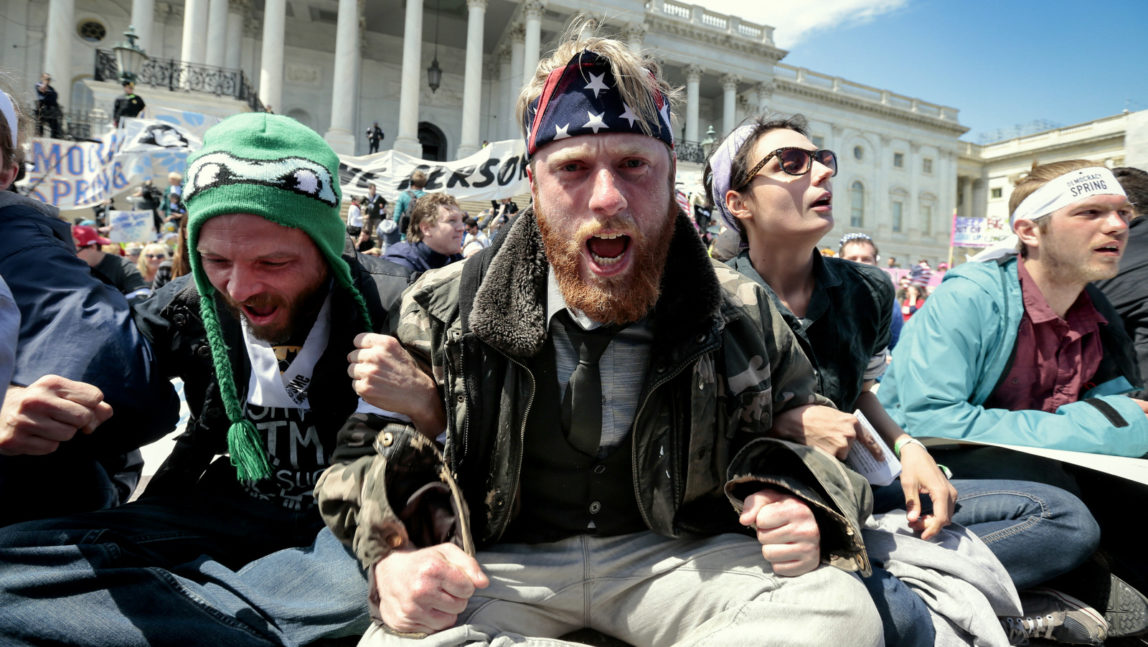 Voting rights reform demonstrators stage a sit-in at the Capitol in Washington, Monday, April 11, 2016, urging lawmakers to take money out of the political process. (AP Photo/J. Scott Applewhite)