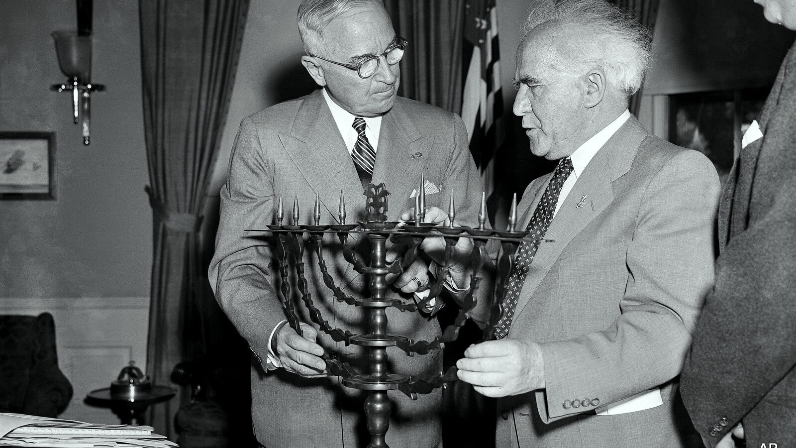President Harry Truman receives an ornate bronze menorah as a birthday gift from David Ben-Gurion, prime minister of Israel, who called on the chief executive to discuss peace and economic development in the Middle East, May 8, 1951. Ben-Gurion said the menorah was made in 1767. This is the president's 67th birthday. (AP Photo/Henry Griffin)