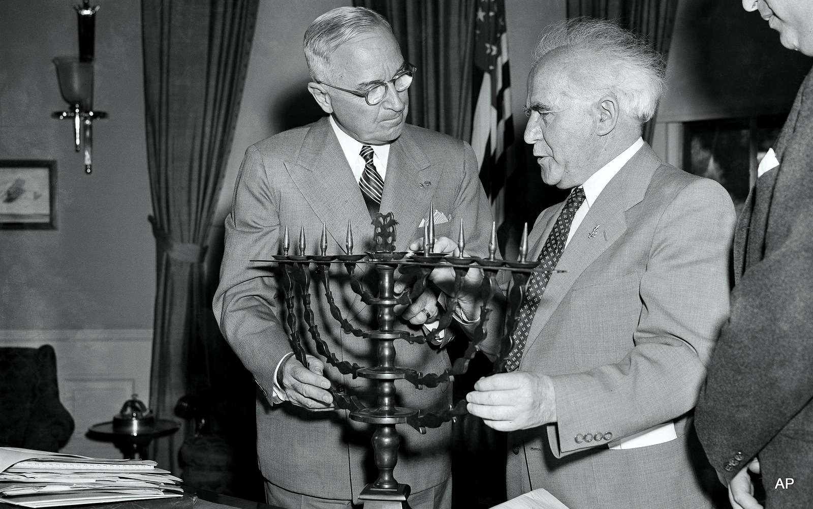 President Harry Truman receives an ornate bronze menorah as a birthday gift from David Ben-Gurion, prime minister of Israel, who called on the chief executive to discuss peace and economic development in the Middle East, May 8, 1951. Ben-Gurion said the menorah was made in 1767. This is the president's 67th birthday. (AP Photo/Henry Griffin)