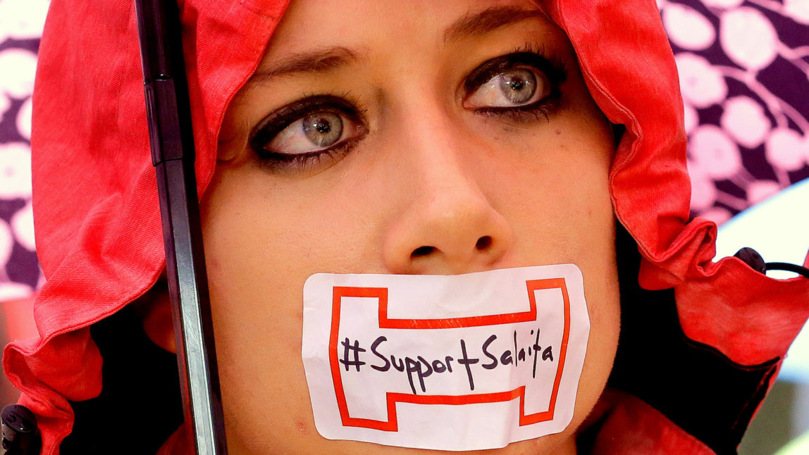 Students tape their mouths shut in support for Steve Salaita, a professor who lost a job offer from the University of Illinois over dozens of Twitter messages critical of Israel. during a rally at the University of Illinois campus Tuesday, Sept. 9, 2014, in Champaign Ill. (AP Photo/Seth Perlman)