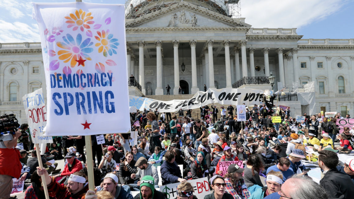 Voting rights reform demonstrators stage a sit-in at the Capitol in Washington, Monday, April 11, 2016, urging lawmakers to take money out of the political process. (AP Photo/J. Scott Applewhite)
