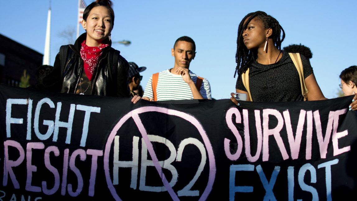 Mitch Xia, left, rallies with other organizers during a march on Franklin Street against N.C. House Bill 2 in Chapel Hill, N.C. (Whitney Keller/The Herald-Sun via AP)