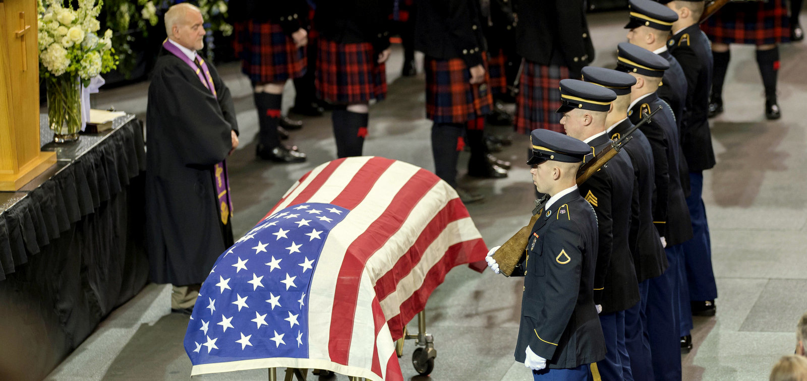 A military honor guard stands by the casket of 33-year-old slain police officer Jason Moszer during his funeral services Monday, Feb. 22, 2016, at Scheels Arena in Fargo. Moszer was shot and killed Feb. 11 while responding to a domestic disturbance.