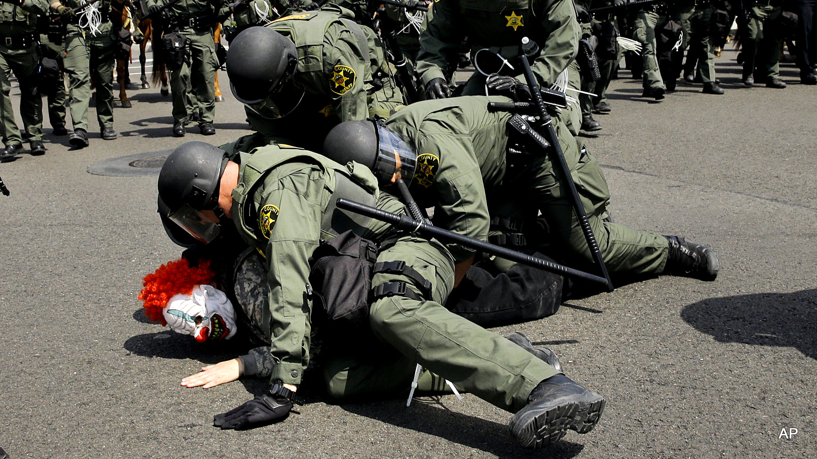 Orange County Sheriff's deputies take a protester into custody near the Anaheim Convention Center Wednesday, May 25, 2016, in Anaheim, Calif. Republican presidential candidate Donald Trump held a rally at the convention center.
