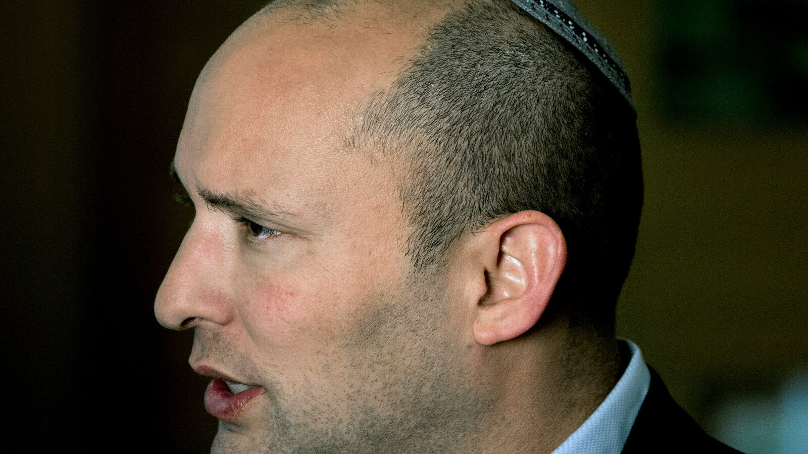 Naftali Bennett, leader of the Jewish Home party, speaks during an interview to The Associated Press in Jerusalem. Israel’s high school civics textbook, slated to be published in March, has become the latest in a string of national battles over what Israeli students learn in school. Three textbook authors have removed their names from chapters they wrote, claiming Education Ministry professionals altered their work beyond recognition. Education Minister Bennet defended the content of the book as “excellent and professional.”
