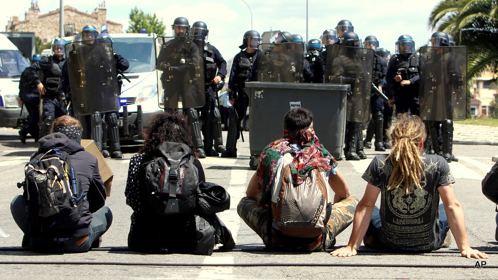 Protestors sit in front of riot police, after a demonstration in Marseille, southern France, Thursday, May 12, 2016. France’s government is facing a major test as lawmakers hold a no-confidence vote, prompted by a deeply divisive labor law allowing longer workdays and easier layoffs. Facing legislative gridlock and daily protests around the country, the Socialist government decided to force the bill through Parliament without a vote.