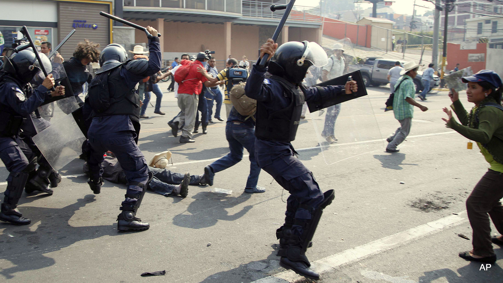 Police attack protesters outside the presidential office in Tegucigalpa, Honduras, Monday, May 9, 2016, after demonstrators tried to break past the security perimeter while demanding justice for the March murder of environmentalist and indigenous leader Berta Caceres. Honduras is one of the most violent countries on the planet by homicide statistics, and one of the most dangerous to be an environmental land activist, per capita, with 109 killed between 2010 and 2015 according to a Global Witness count.