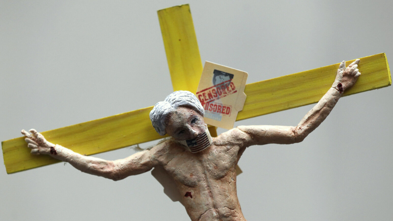 A figure depicts Julian Assange on a cross on top of a supporter of WikiLeaks founder Julian Assange during a vigil outside the Ecuadorian Embassy in London. (AP /Sang Tan)