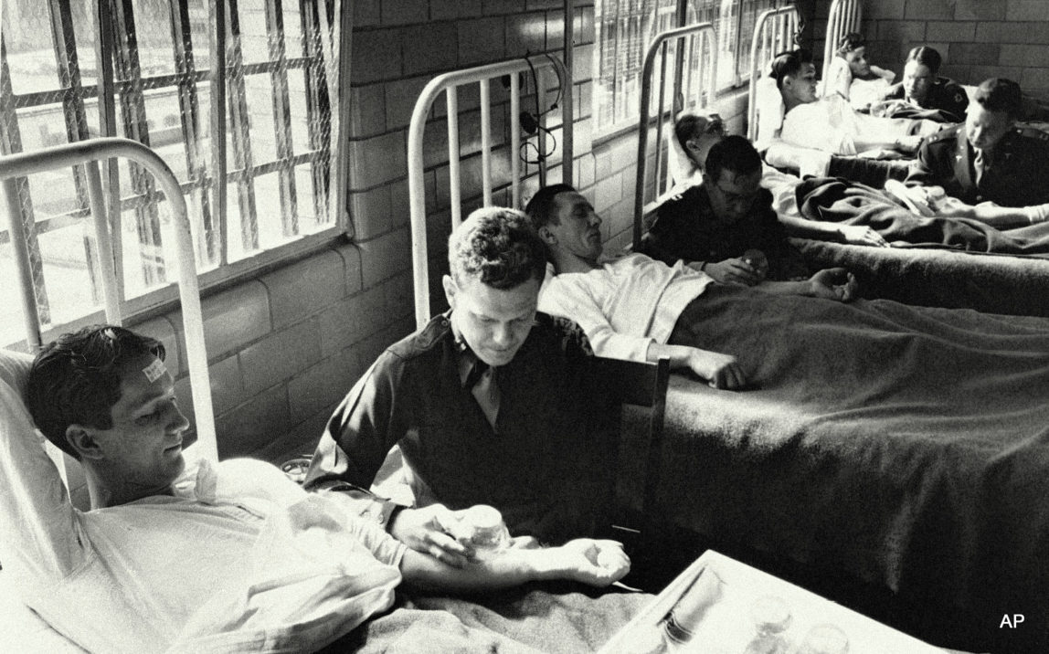 FILE - In this June 25, 1945 picture, army doctors expose patients to malaria-carrying mosquitoes in the malaria ward at Stateville Penitentiary in Crest Hill, Ill.