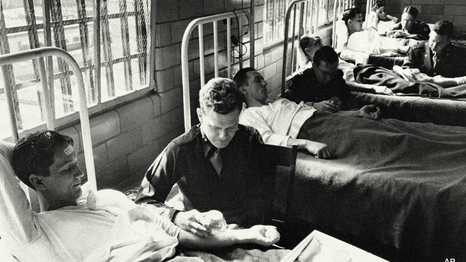 FILE - In this June 25, 1945 picture, army doctors expose patients to malaria-carrying mosquitoes in the malaria ward at Stateville Penitentiary in Crest Hill, Ill.