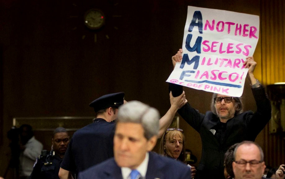 Former Coloado County Commissioner, and Senate Candidate Arn Menconi as he protested during John Kerry's testimony before the Senate Foreign Relations Committee. Kerry was asking the Senate to authorize military force against ISIS. Menconi called for the end of the "endless war. (Photo: http://arnmenconi.com)