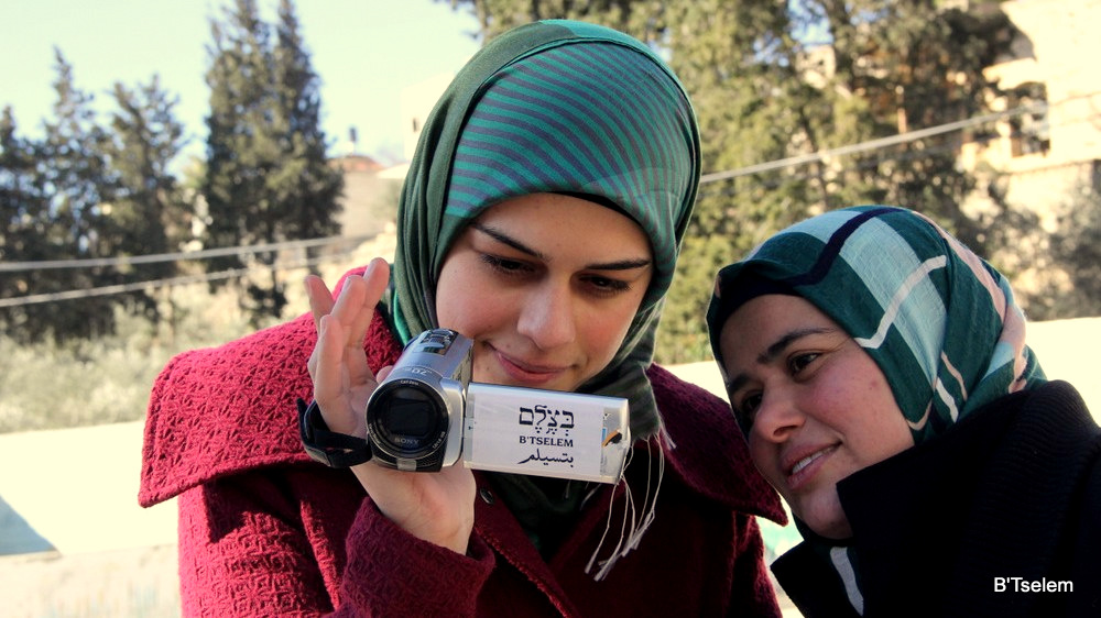 Palestinian volunteers with the B'Tselem human rights organization learn how to use video cameras to document the actions of the IDF and Israeli settlers in the West Bank, in 2014.