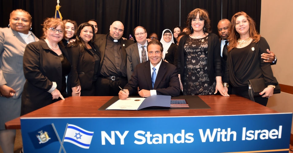 Governor Andrew M. Cuomo signs a first-in-the-nation Executive Order directing the divestment of public funds supporting the Boycott, Divestment and Sanctions (BDS) campaign against Israel during a breakfast meeting at the Harvard Club. Afterwards, (Photo: Kevin P. Coughlin/Office of Governor Andrew M. Cuomo)