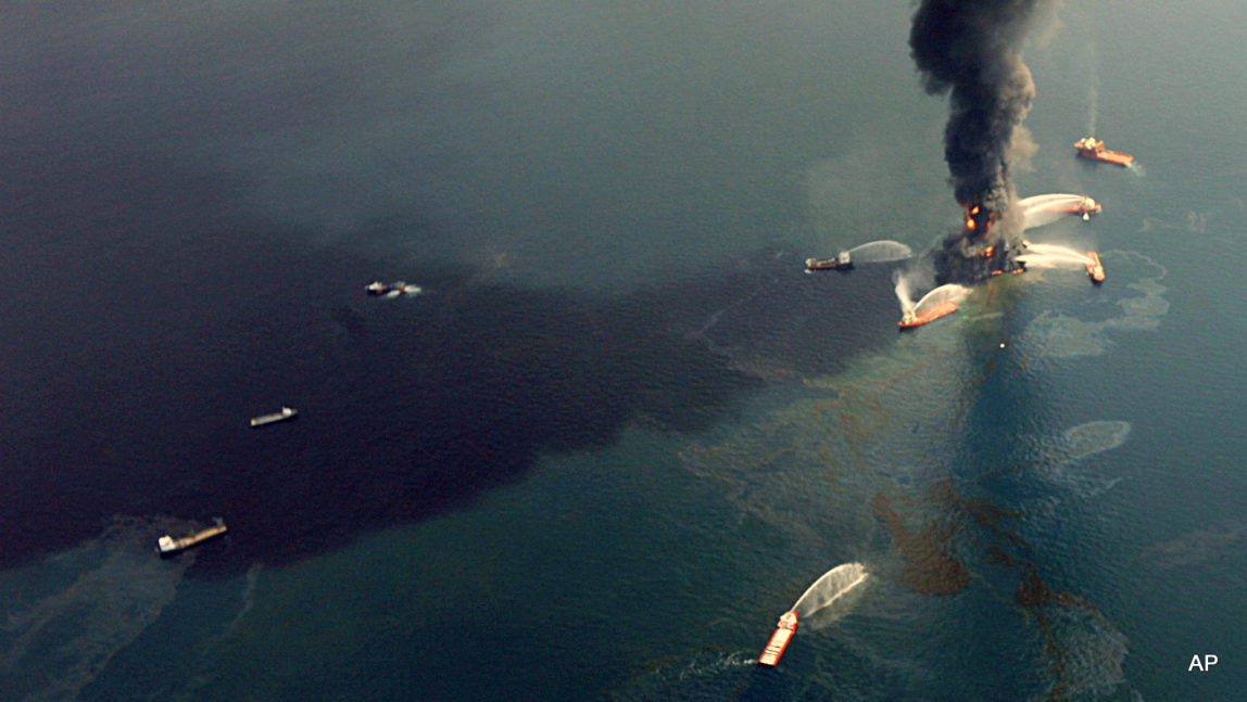 This Wednesday, April 21, 2010 aerial photo shows oil in the Gulf of Mexico, more than 50 miles southeast of Venice on Louisiana's tip, as the Deepwater Horizon oil rig burns.