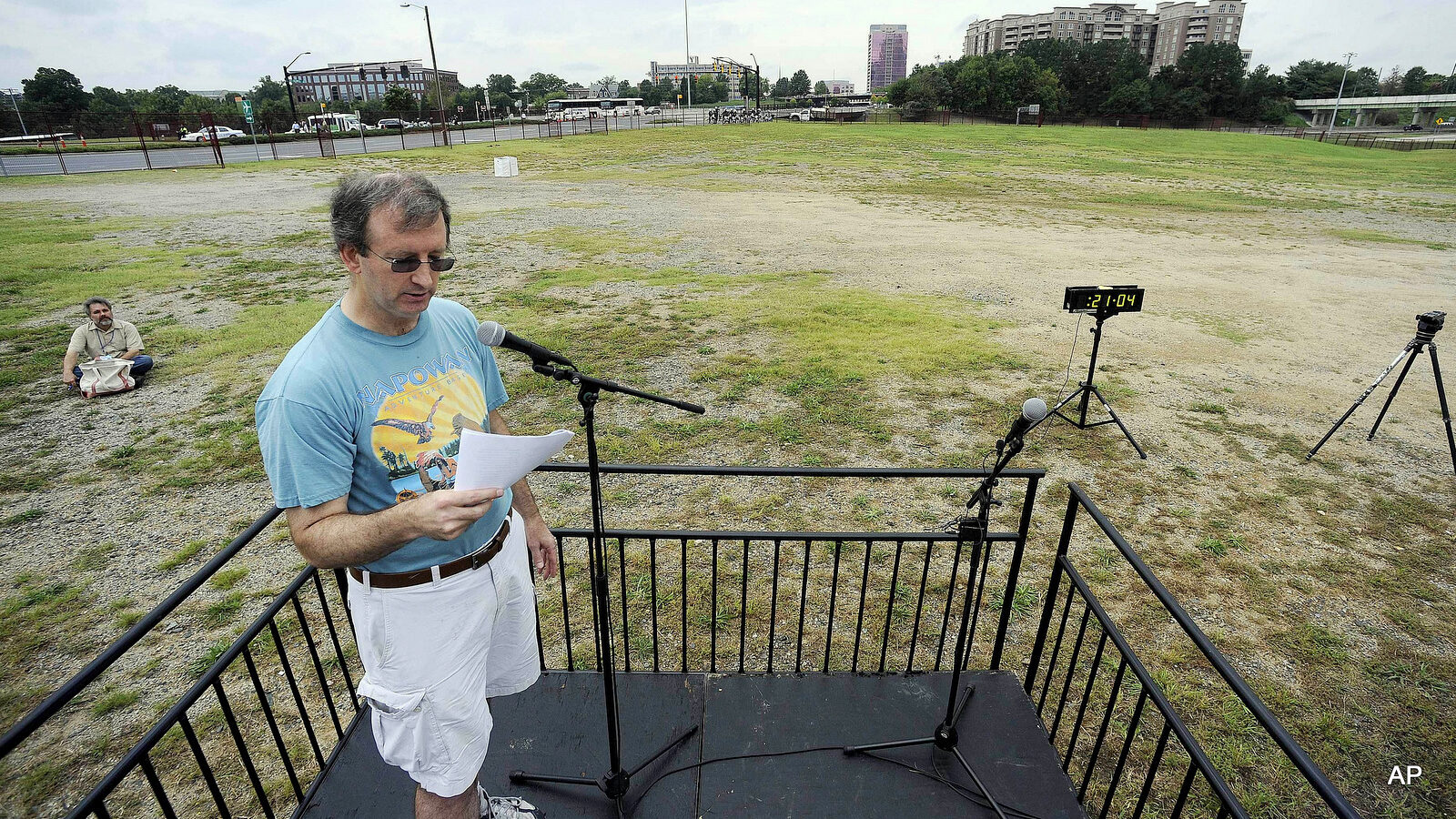 Chris Kite with the Community Singers speaks with one person listening, in the "Free Speech Area," during the 2012 Democratic National Convention.