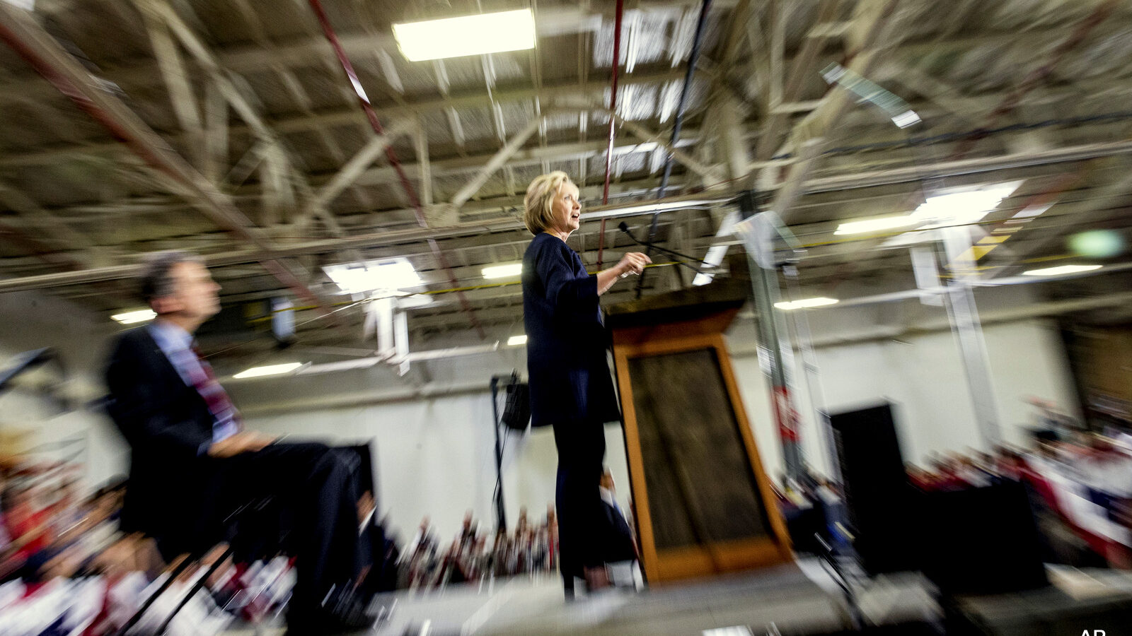 Democratic presidential candidate Hillary Clinton, center, accompanied by Sen. Sherrod Brown, D-Ohio, left, speaks at a rally.