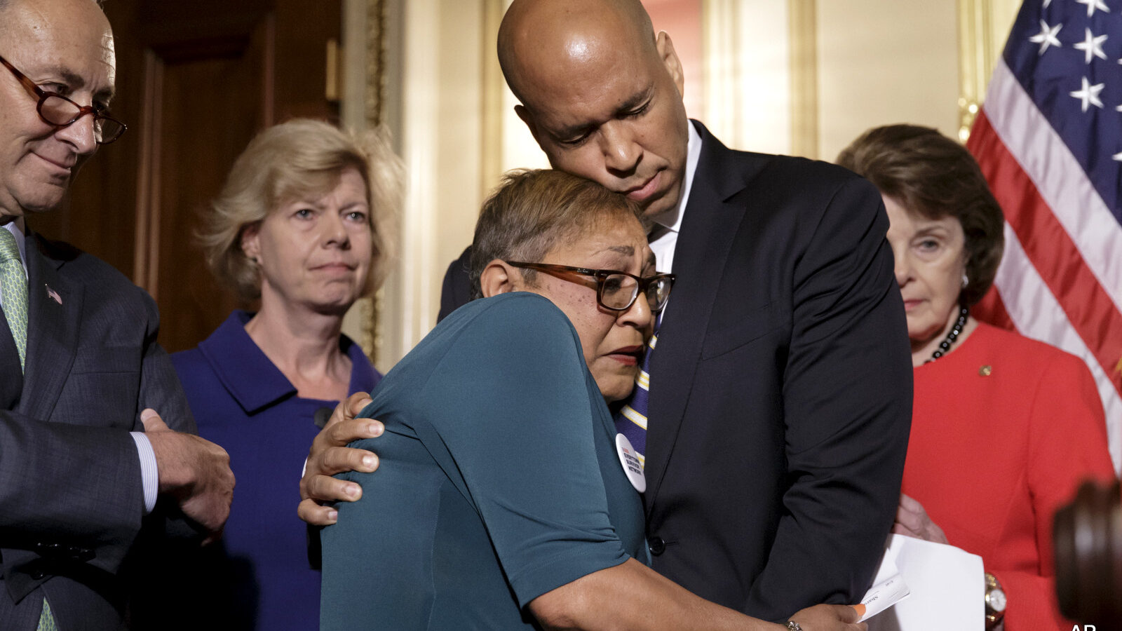 Rev. Sharon Risher, Risher, a clinical trauma chaplain in Dallas, who lost her mother Ethel Lance and two cousins in the racially-motivated shooting at the historic Emanuel AME Church in Charleston, N.C., in 2015, is embraced by Sen. Cory Booker, D-N.J., during a news conference by Democratic senators calling for gun control legislation in the wake of the mass shooting in an Orlando LGBT nightclub this week, Thursday, June 16, 2016, on Capitol Hill in Washington. From left are, Sen. Charles Schumer, D-N.Y., Sen. Tammy Baldwin, D-Wis., and Sen. Dianne Feinstein, D-Calif. (AP Photo/J. Scott Applewhite)