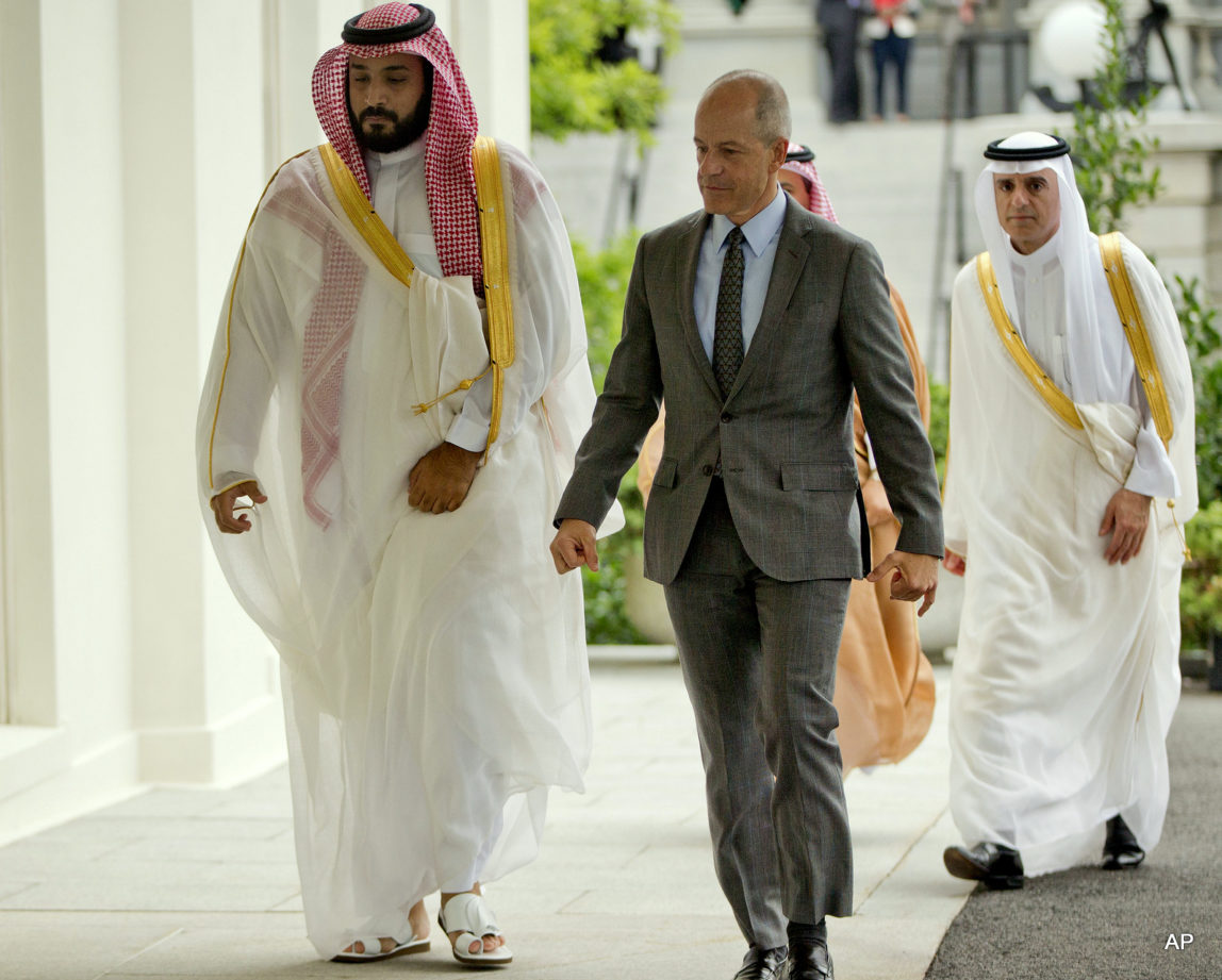 Saudi Arabia's Deputy Crown Prince Mohammed bin Salman, left, walks into the West Wing of the White House in Washington escorted by Mark E. Walsh, center, Deputy Chief of Protocol, Friday, June 17, 2016.