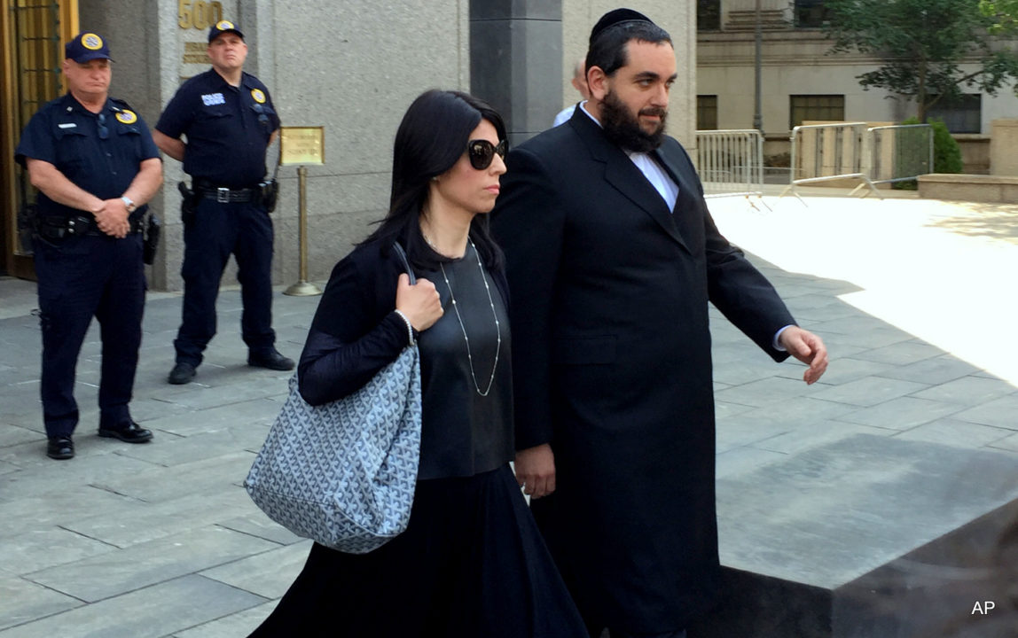 Brooklyn businessman Jeremy Reichberg, right, leaves Manhattan federal court in New York, Monday, June 20, 2016, after he was charged with showering New York Police Department officials with tens of thousands of dollars in bribes, including vacations, prostitutes and home improvements so that he could use the NYPD as his private police force.