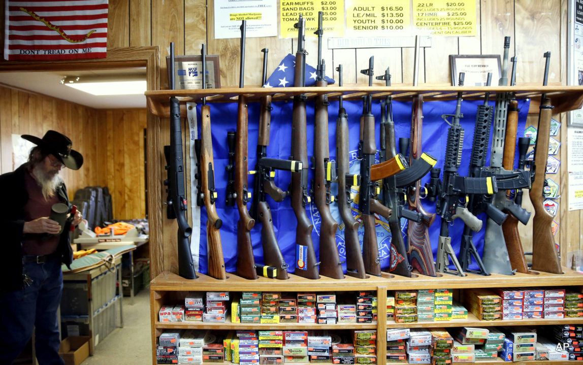In this March 15, 2016 photo, guns for rent are on display at a shooting range and retail store in Cherry Creek, Colo. . Across the U.S., suicides account for nearly two-thirds of all gun deaths, with 21,334 gun deaths by suicide in 2014, according to federal data. (AP Photo/Brennan Linsley)