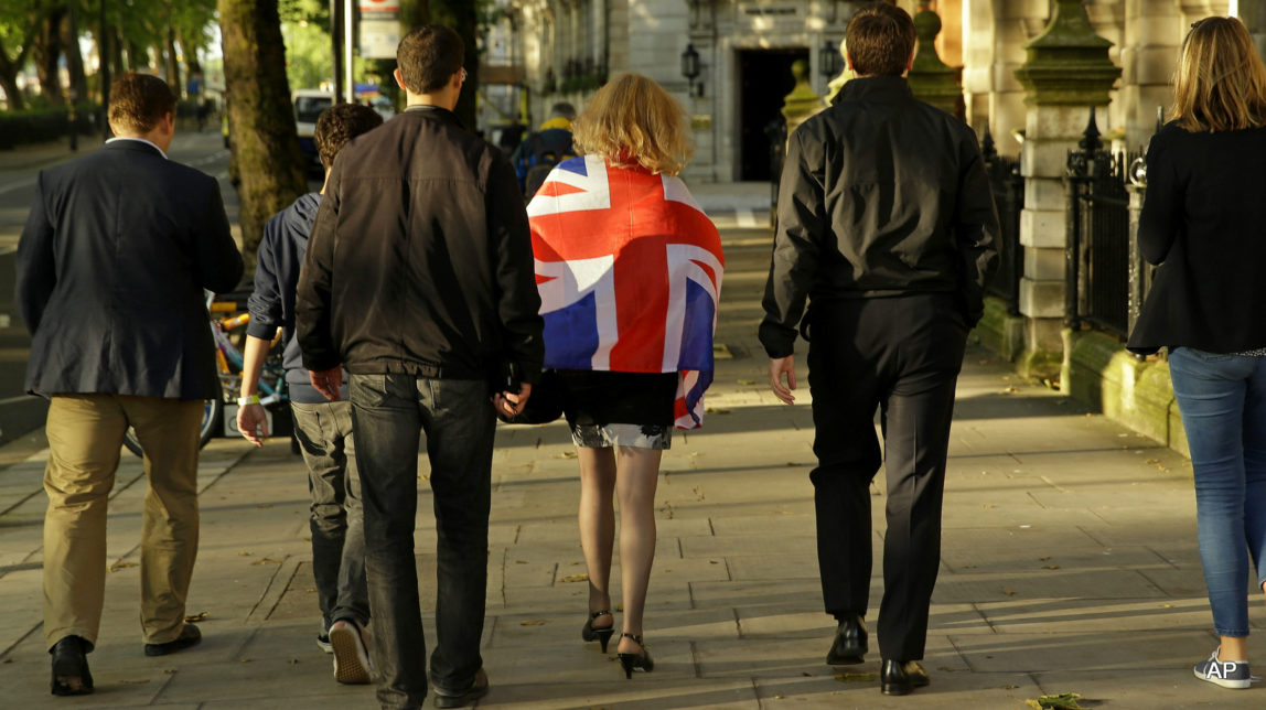 Vote Leave supporters walk along a street in central London, Friday, June 24, 2016. Britain entered uncharted waters Friday after the country voted to leave the European Union.