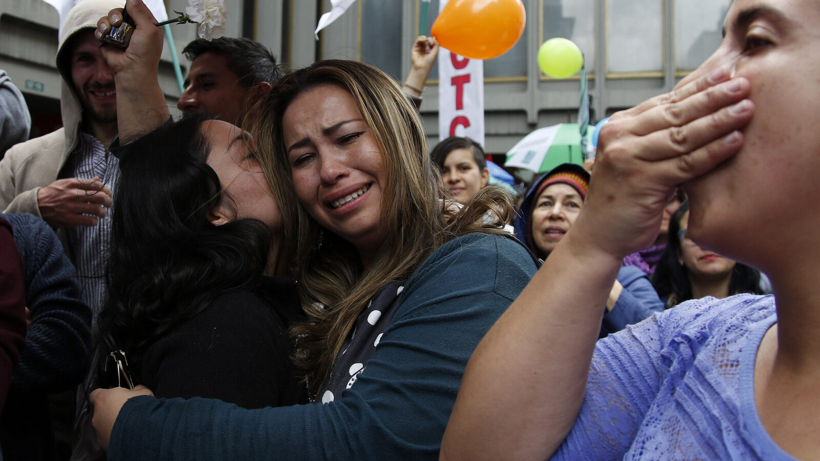 People celebrate the agreement between Revolutionary Armed Forces of Colombia, FARC, and Colombia's government, in Bogota, Colombia, Thursday, June 23, 2016.